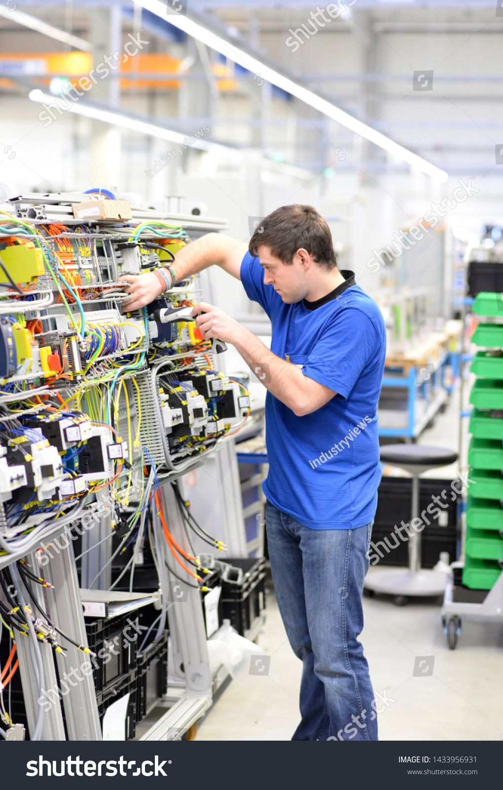 mechanical engineering company on young apprentice worker in an industrial company assembling electronic components in the mechanical engi industrial companies apprentice mechanical engineering